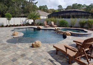 Custom Concrete Pool with rock waterfall and beach entry in Deland