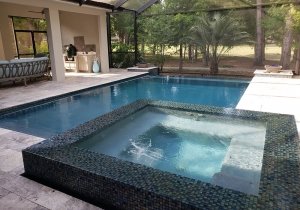 Perimeter overflow spa with slot detail, fire bowls, vanishing edge, picture window screen, sliver travertine decking with infinity edge coping and glass tile spa/waterline